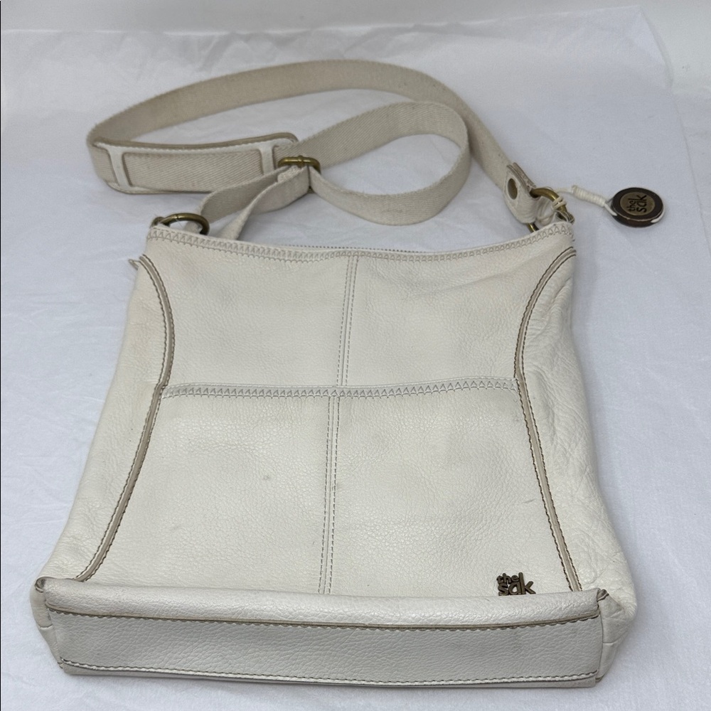 The Sak White Leather Crossbody Bag Canvas Strap Botanical Lining logo Charm